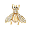 Bee brooch with gold-tone finish, clear round stones and large amber-tone faceted center, cutout on white background.