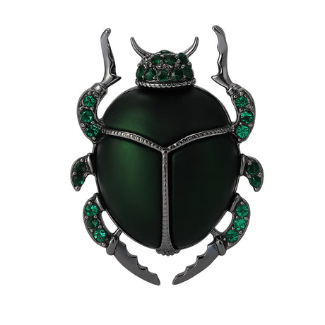 Beetle brooch with green body, dark metallic legs, and green faceted stones, cutout on white background.