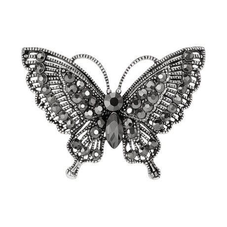 Butterfly brooch with dark gunmetal-tone base and clustered black faceted stones, cutout on white background.