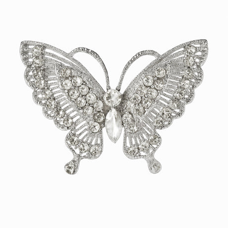 Butterfly brooch with silver-tone base and clear faceted stones arranged in layered pattern, cutout on white background.