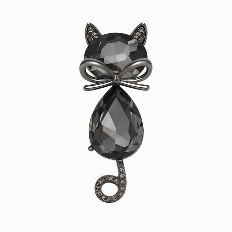 Cat brooch with black faceted stones, gunmetal-tone bow detail, and curled tail with clear stones, cutout on white.