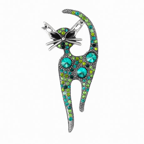Cat brooch covered with round faceted stones in various sizes and shades of green, set in antique-style silver-tone metal. Cutout on white.