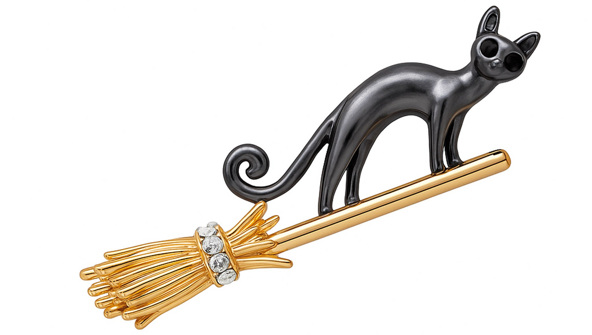 Cat brooch with smooth black enamel finish on gold-tone broomstick accented with clear round stones, cutout on white background. Landscape crop for secondary use.