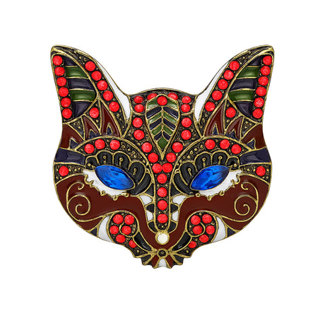Cat brooch with red-brown enamel, blue faceted eyes, green and white accents, cutout on white background.