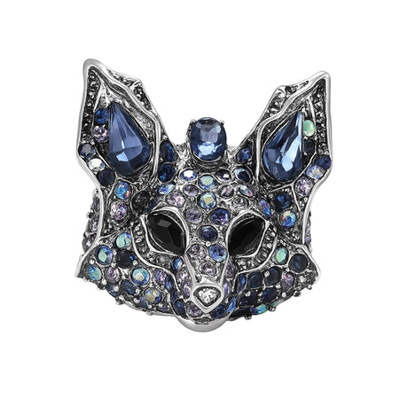 Fox brooch with silver-tone metal, faceted stones in various shades of blue, and black eyes, cutout on white.
