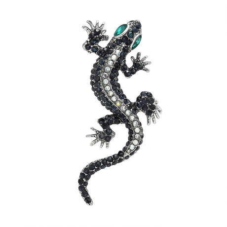 Gecko lizard brooch with silver-tone body, clear and dark faceted stones, and green-toned eyes, cutout on white background.