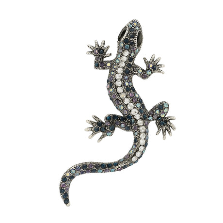 Gecko lizard brooch with silver-tone metal finish, iridescent blue and purple faceted stones, and black eyes, cutout on white background.