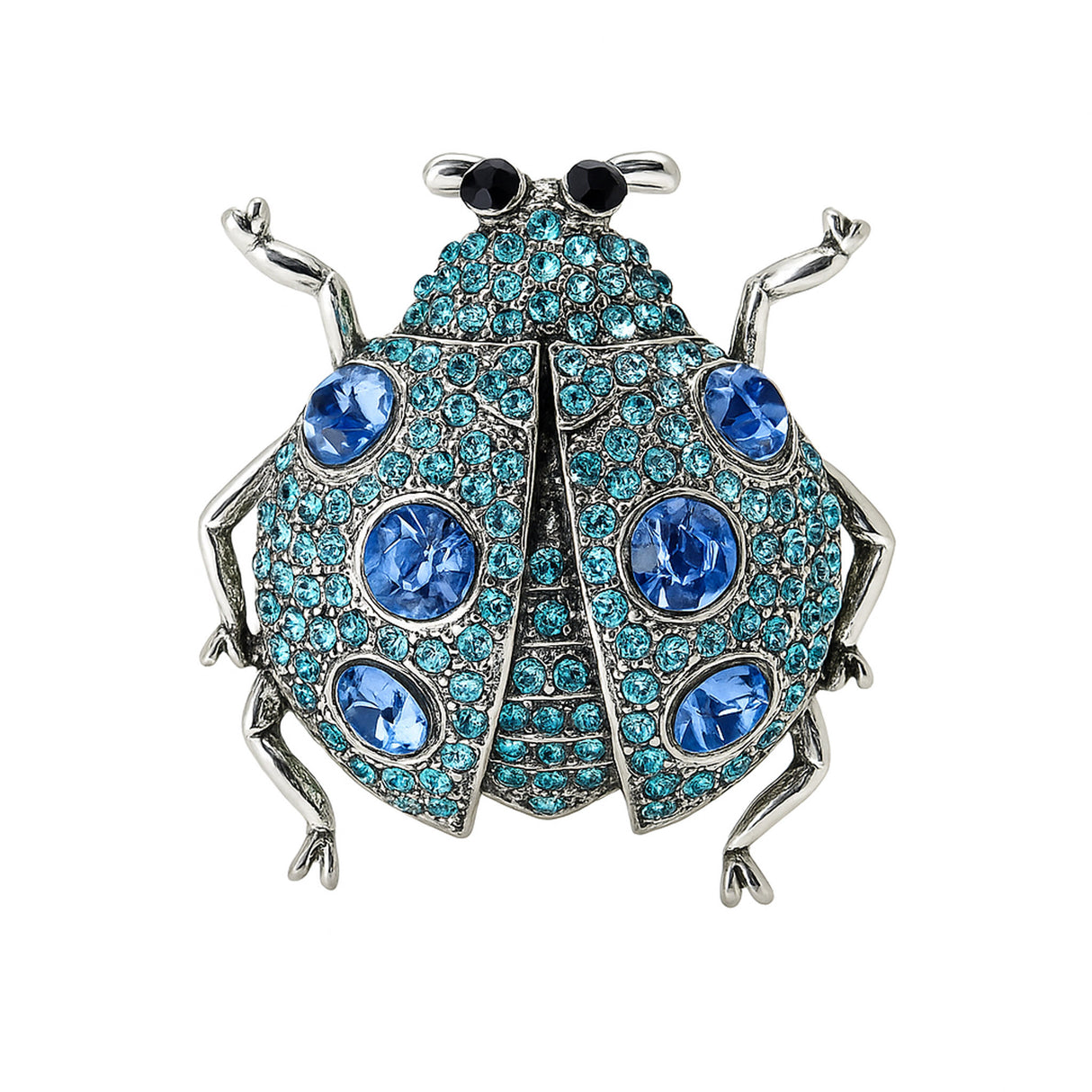 Ladybug brooch with silver-tone metal, blue faceted stones, and black eyes, cutout on white.