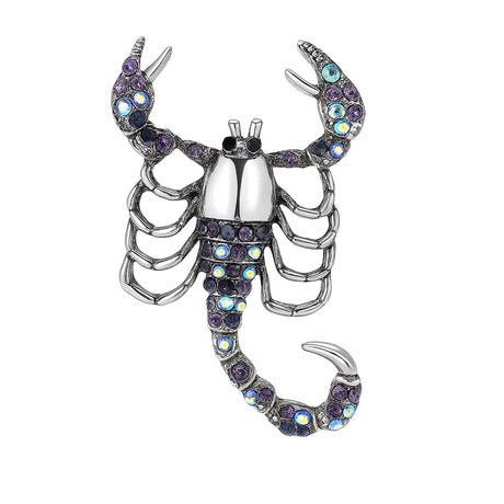 Scorpion brooch with silver-tone body, purple-blue iridescent stones, and raised claws, isolated on white background.