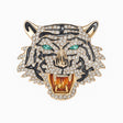 Roaring tiger head brooch with gold-tone base, clear faceted stones, black enamel stripes, and green-tone eyes, cutout on white.