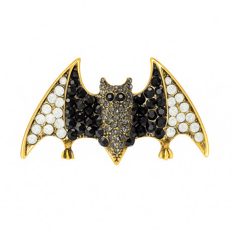 Bat brooch with black and white faceted stones on gold-tone base, cutout on white.