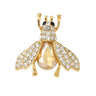 Bee brooch with gold-tone finish, clear round stones and large amber-tone faceted center, cutout on white background.