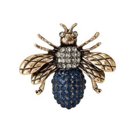 Bee brooch with antique gold-tone wings, clear stones on thorax, and round blue clustered stones on rest of the body, cutout on white background.