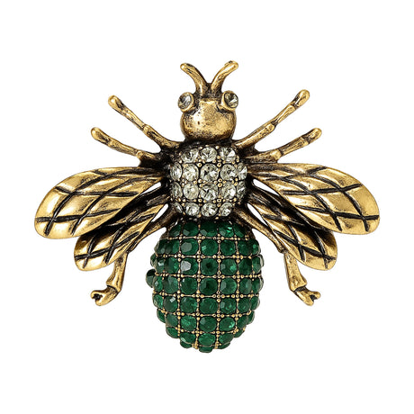 Bee brooch with antique gold-tone wings, clear stones on head, and green round clustered stones on body, cutout on white background.