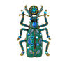 Beetle brooch with teal green enamel wings, blue faceted stones, and gold-tone detailing, cutout on white.