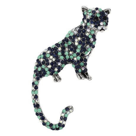 Silver-tone leopard brooch with navy, aqua, and opalescent rhinestones. Elegant jungle cat silhouette with curved tail, shown on a white cutout background.