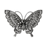 Butterfly brooch with dark gunmetal-tone base and clustered black faceted stones, cutout on white background.