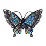 Butterfly brooch with dark metal base, black faceted stones with iridescent blue accents, cutout on white background.
