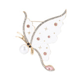 Butterfly brooch with white wings, pink round stones, clear teardrop detail, and faux pearl accent, cutout on white background.