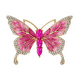 Butterfly brooch with pink enamel wings, gold-tone metal frame, small clear round stones along edges, and three large pink oval faceted stones as the body, cutout on white.