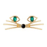 Cat face brooch with gold-tone metal, green oval stones for eyes, and black round nose, cutout on white.