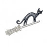Cat brooch with sleek black enamel body on silver-tone metal broomstick accented with clear round stones, isolated on white background.