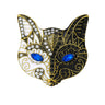 Cat mask brooch with black and white enamel finish, blue faceted eyes, clear and black stones, cutout on white background.