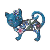 Cat brooch with blue enamel finish, multicolor faceted stones, floral accents, and green leaf motif, cutout on white.