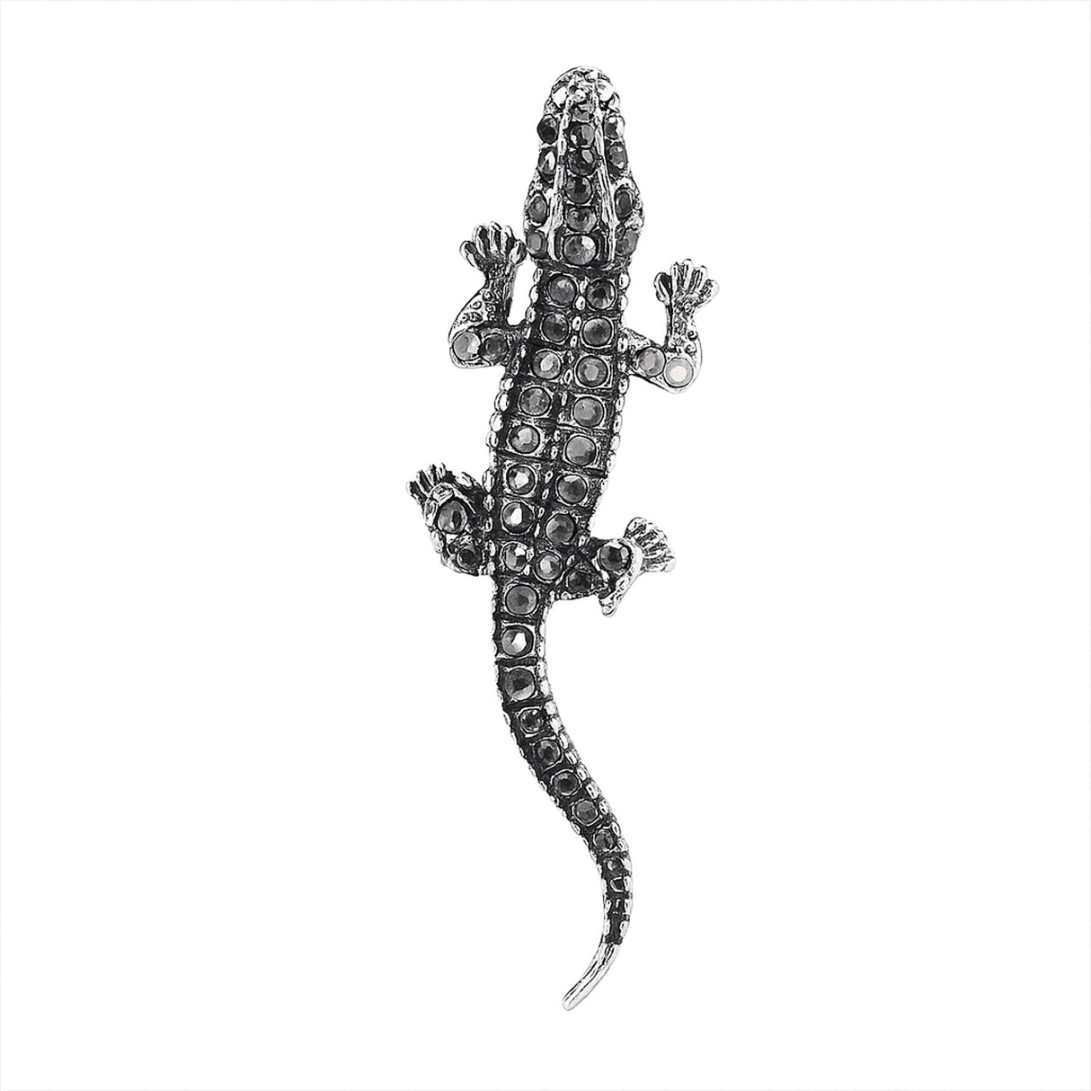 Lizard brooch with silver-tone metal finish and black faceted stones, top-down view, cutout on white background.