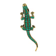 Lizard brooch with gold-tone metal base and green faceted stones, top-down view, cutout on white background.