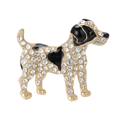 Dog brooch with black enamel patches, clear faceted stones, and gold-tone metal finish, cutout on white background.