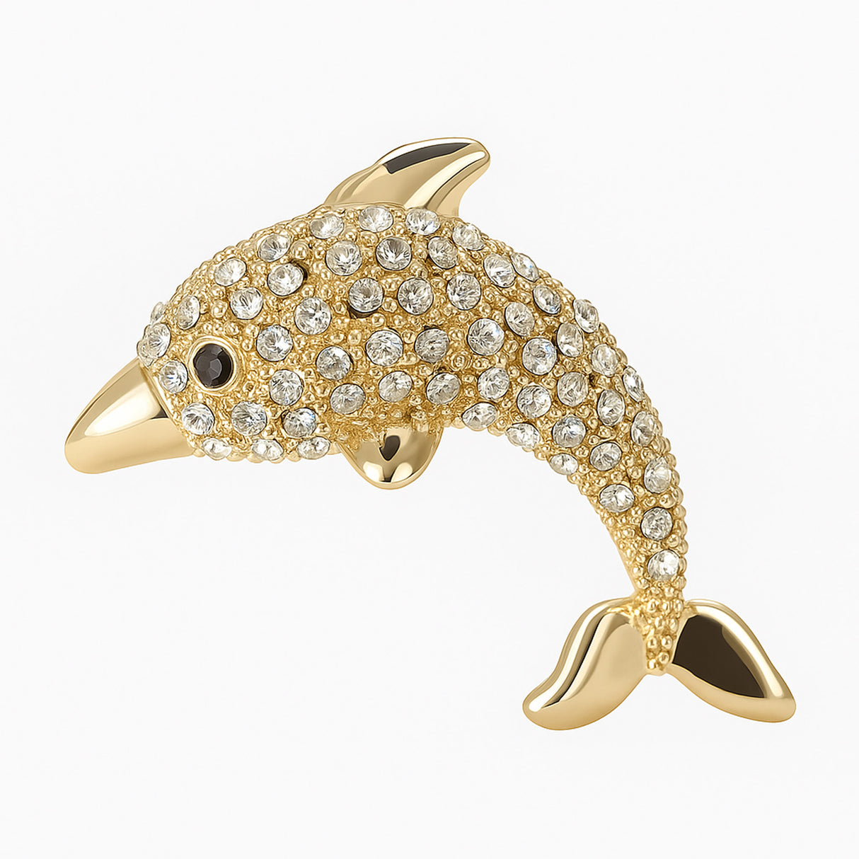 Dolphin brooch with polished gold-tone finish and clear faceted stones, cutout on white background.