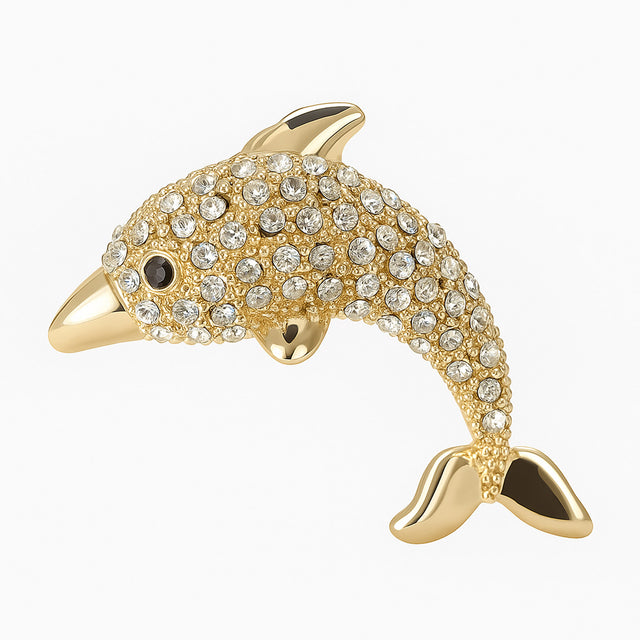 Dolphin brooch with polished gold-tone finish and clear faceted stones, cutout on white background.