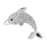 Dolphin brooch in polished silver-tone with clear faceted stones and black eye detail, cutout on white.