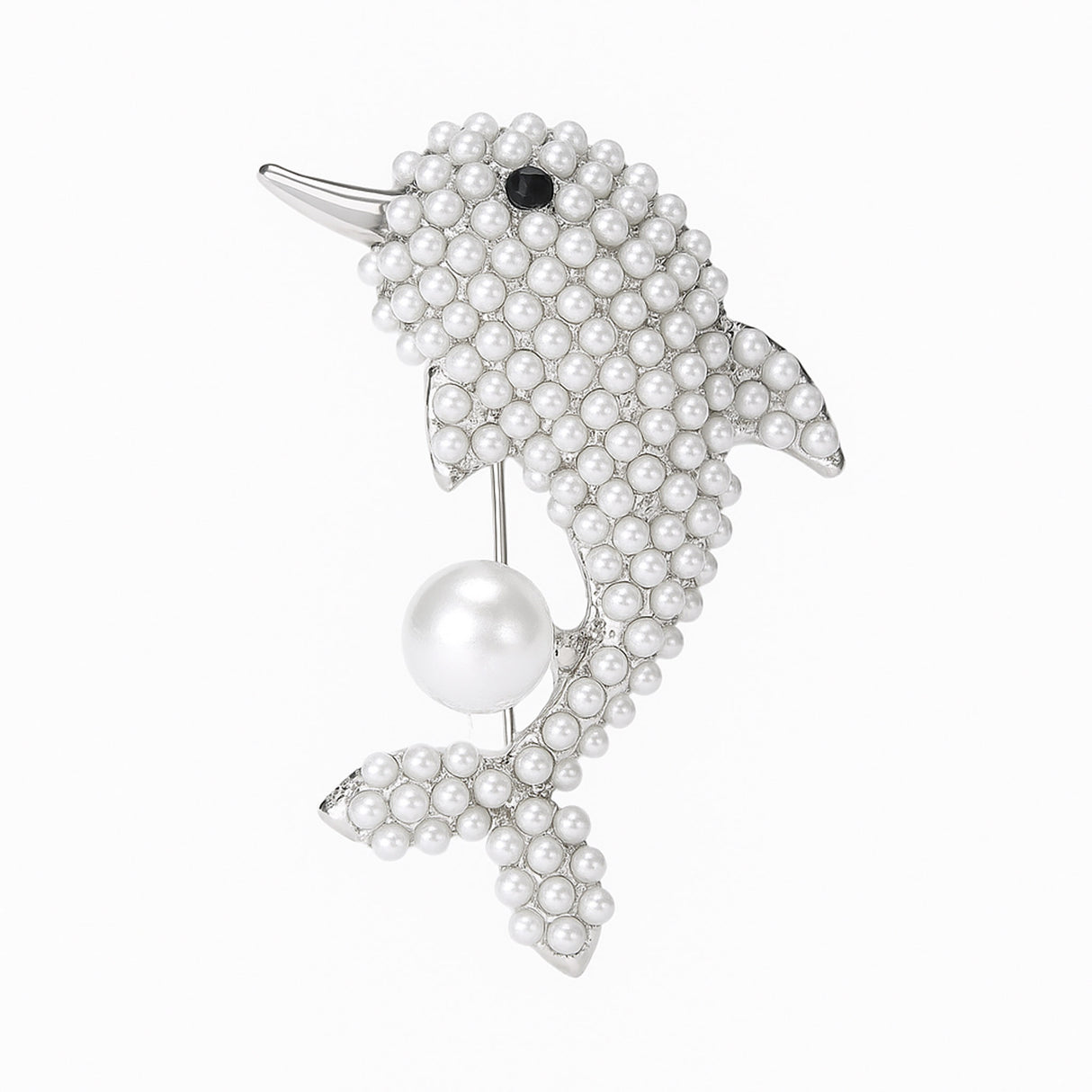 Dolphin brooch with silver-tone metal finish, covered in small white round beads, black eye detail, and suspended imitation pearl, cutout on white background.