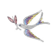 Dove brooch with multicolor wings in yellow, pink, and blue tones, clear faceted stones on body, and pink leaf detail, cutout on white background.