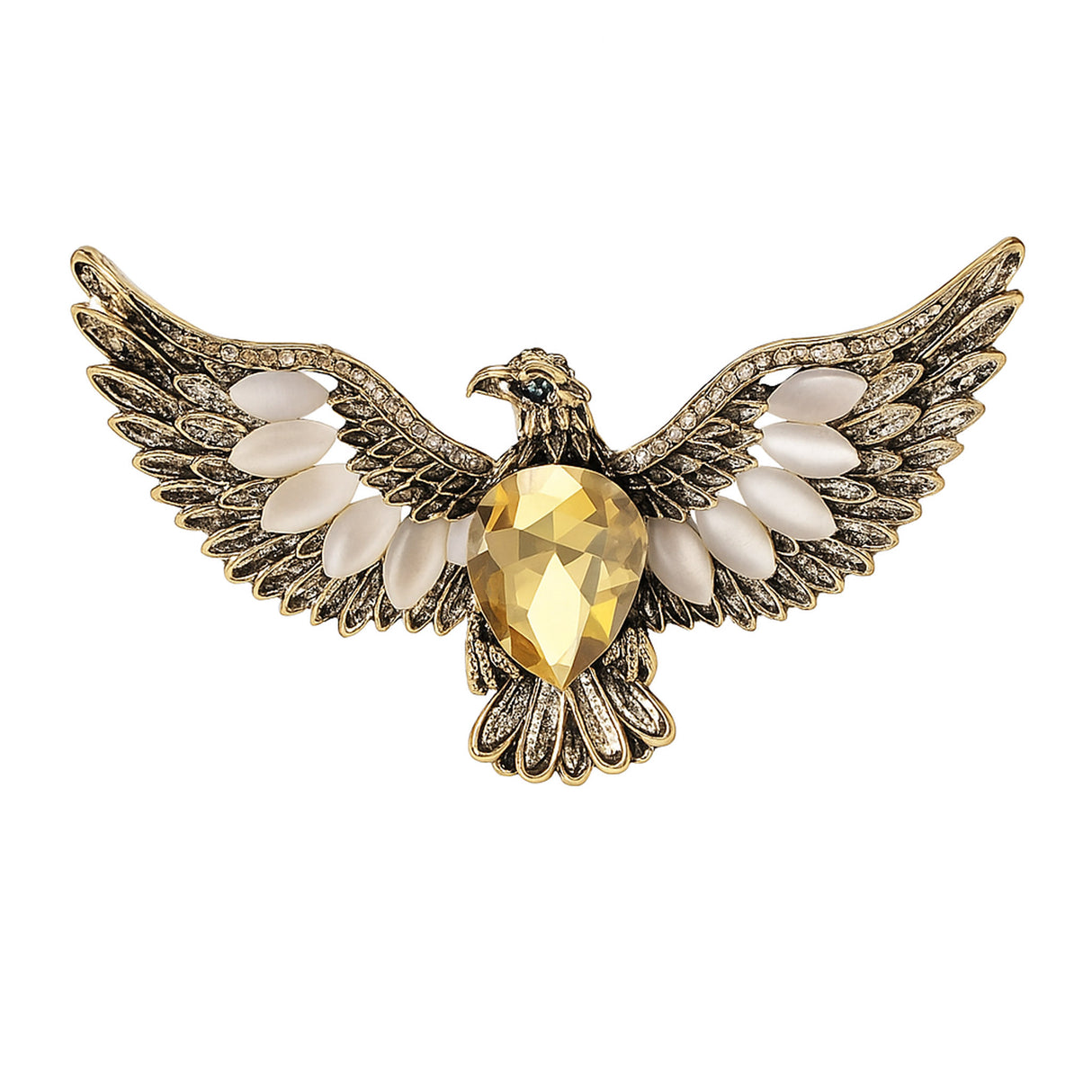 Eagle brooch with gold-tone metal, large yellow faceted center stone, and white accent stones, cutout on white.