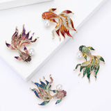 Set of four fish brooches with multicolor enamel fins, faceted stones, and imitation pearls, flat lay on white platforms.