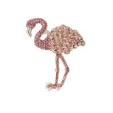 Flamingo brooch with pink stones and round iridescent accents on wings, cutout on white background.