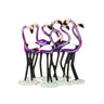 Flamingo brooch showing group of purple birds, with white wings, and black legs on green-blue base, cutout on white.