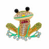 Frog brooch with gold-tone base, multicolor faceted stones, black eyes, and green enamel accents, cutout on white.