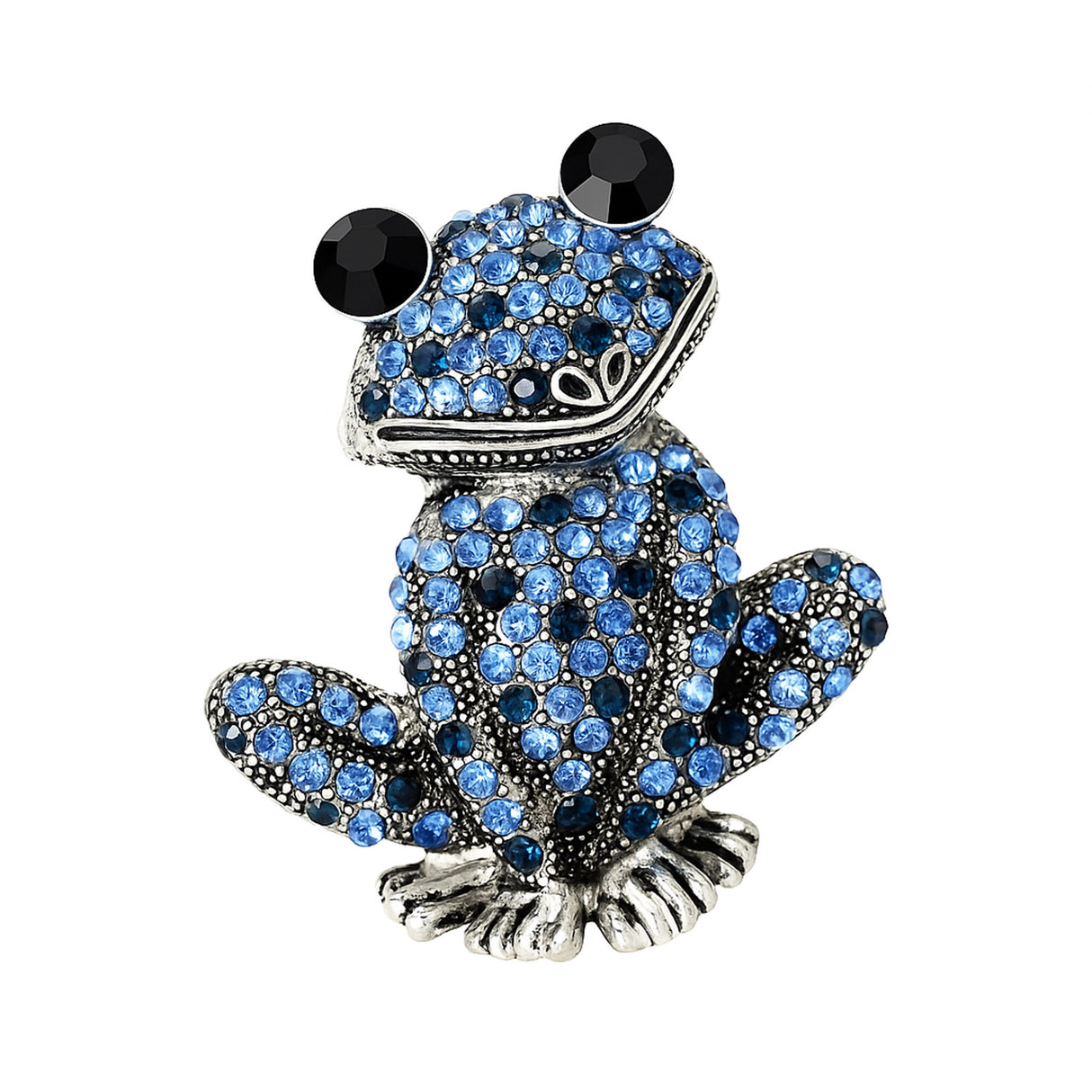 Frog brooch with silver-tone metal, light and dark blue faceted stones, and black round eyes, cutout on white.