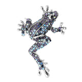 Frog brooch with silver-tone base, covered in blue and purple faceted stones, cutout on white background.