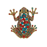 Frog brooch with gold-tone metal base, featuring red, teal, and pink faceted stones, cutout on white background.