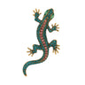 Gecko lizard brooch with teal body, pink faceted center stones, green eyes, and gold-tone claws, cutout on white.