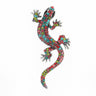 Gecko lizard brooch with multicolor faceted stones in pink, red, blue, and green tones, black eyes, cutout on white.