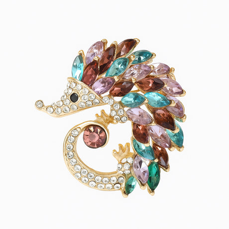 Hedgehog brooch with gold-tone base, small clear stones, and larger marquise-cut stones in shades of pink, red, brown and blue. Cutout on white.
