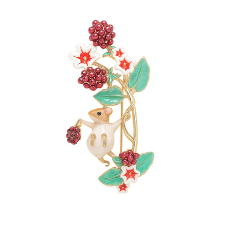 Mouse brooch with gold-tone metal base, white enamel body, red clustered bead berries, and green leaves, cutout on white.