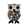Owl brooch with silver-tone frame, large black eyes, and multicolor faceted stones including brown, amber, blue and white, with black oval stones with pointed tips for feet, cutout on white.