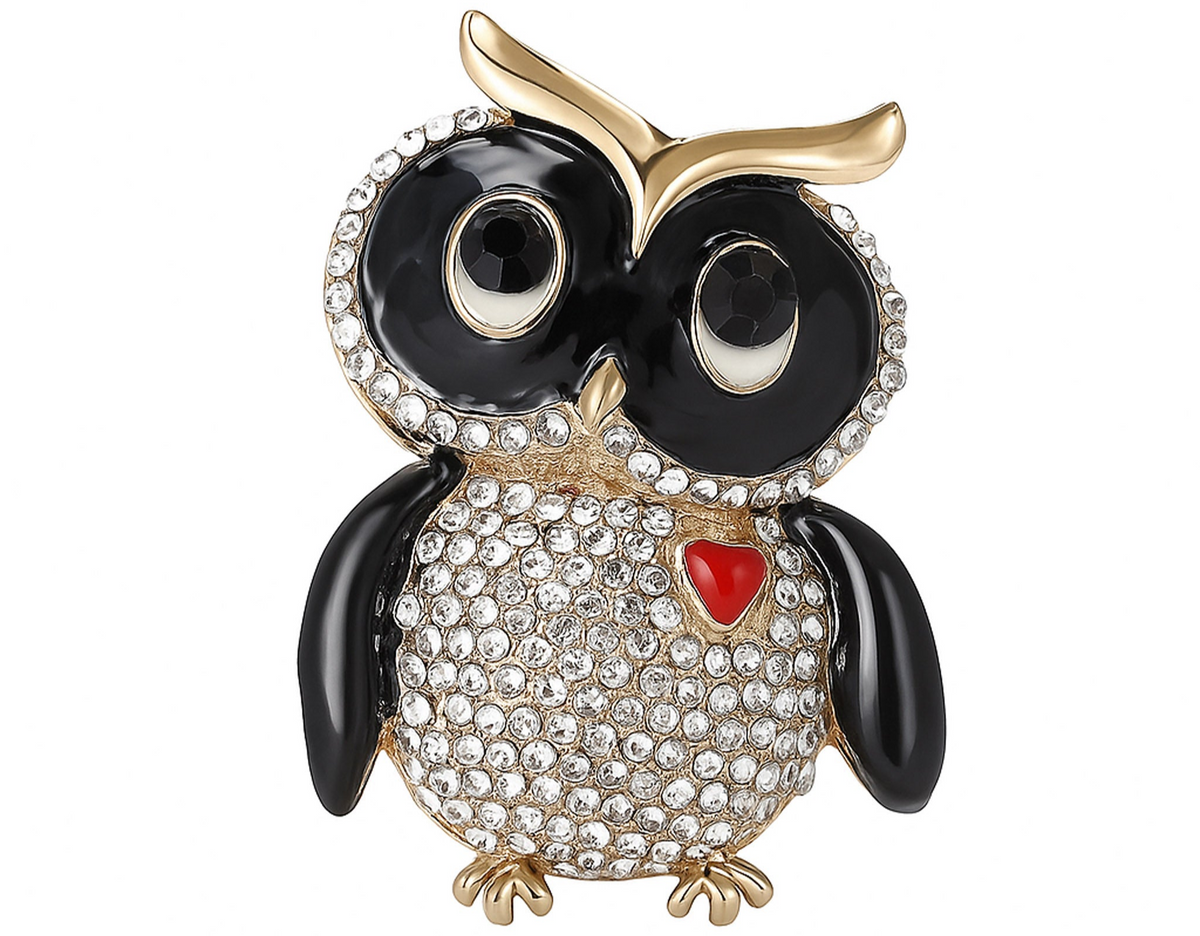 Owl brooch with black round faceted rhinestone eyes and black enamel wings, clear pave stones on the body, red heart detail, and gold-tone accents, cutout on white. Landscape crop for secondary use.